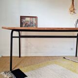 Table with tubular metal legs and wooden top.