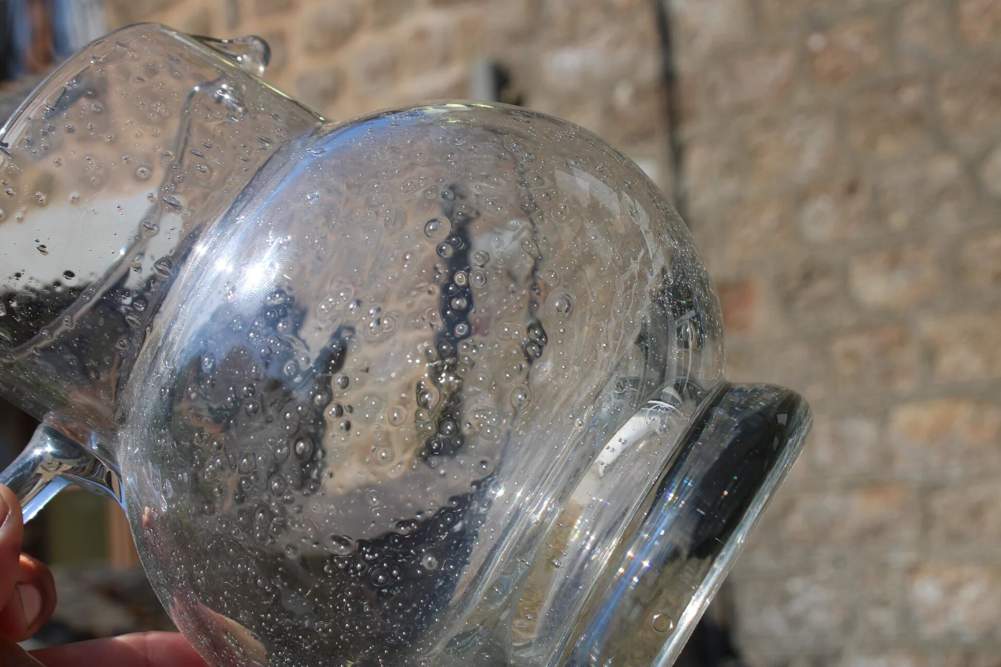 Vintage blown glass pitcher with bubbles, transparent.