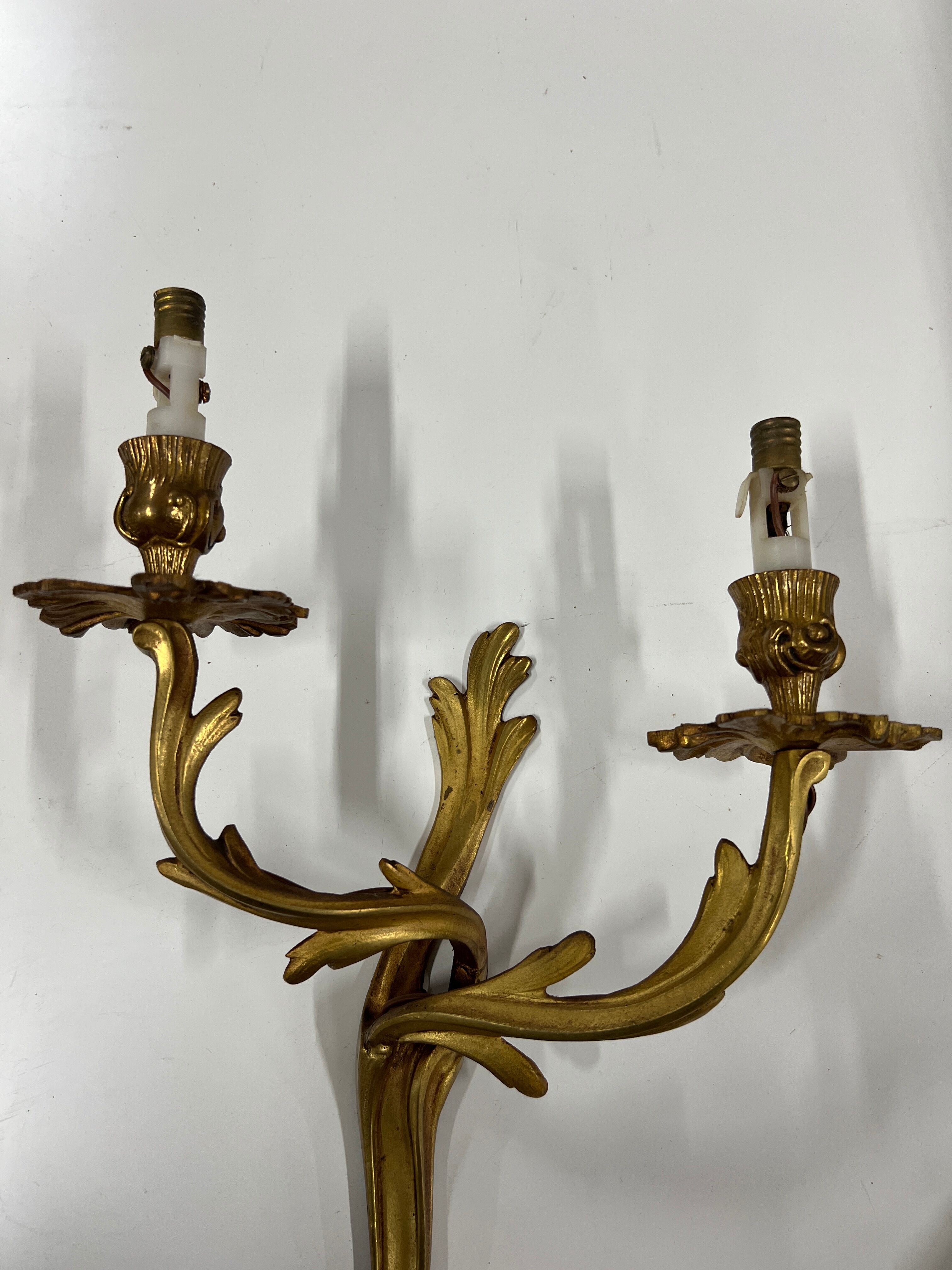 Pair of Louis XV wall lamps in gilded bronze