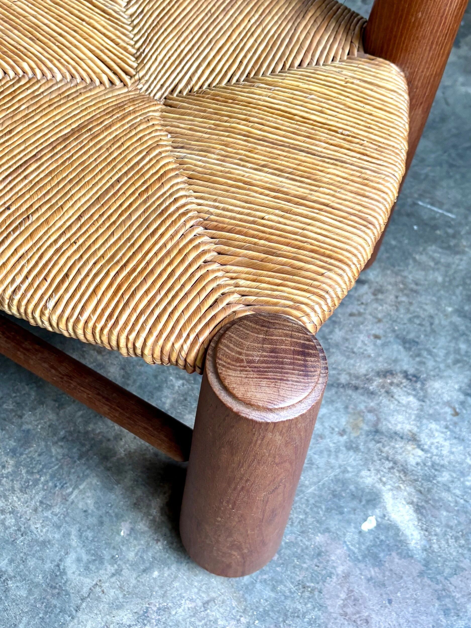 Brutalist low chair in dark wood and straw no. 3