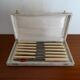 12 vintage stainless steel knives bone or bakelite sleeves in case