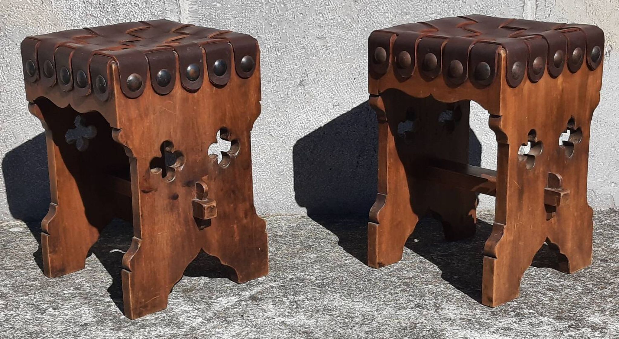 Pair of brutalist stools, leather seat.