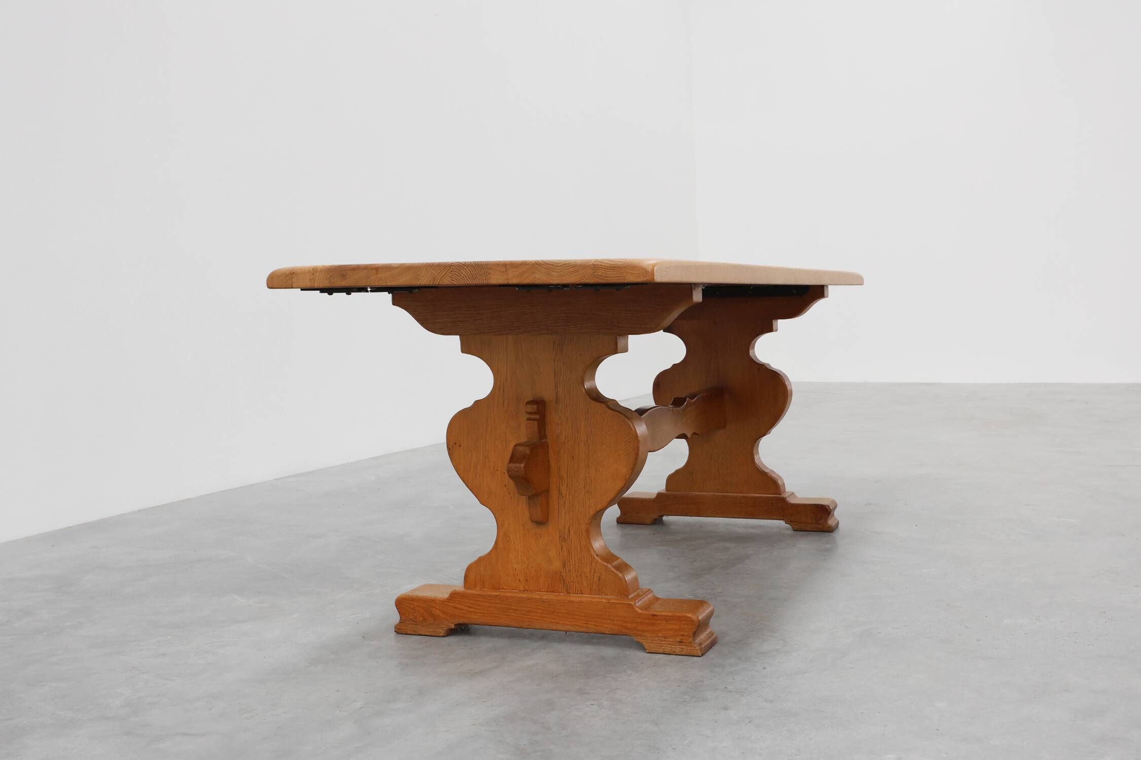 20th Century French oak trestle table with scalloped legs and plank top