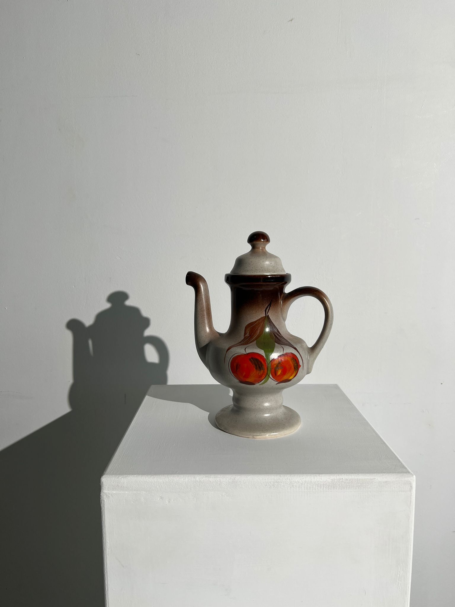 Vintage stoneware teapot with flower and fruit patterns