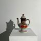 Vintage stoneware teapot with flower and fruit patterns