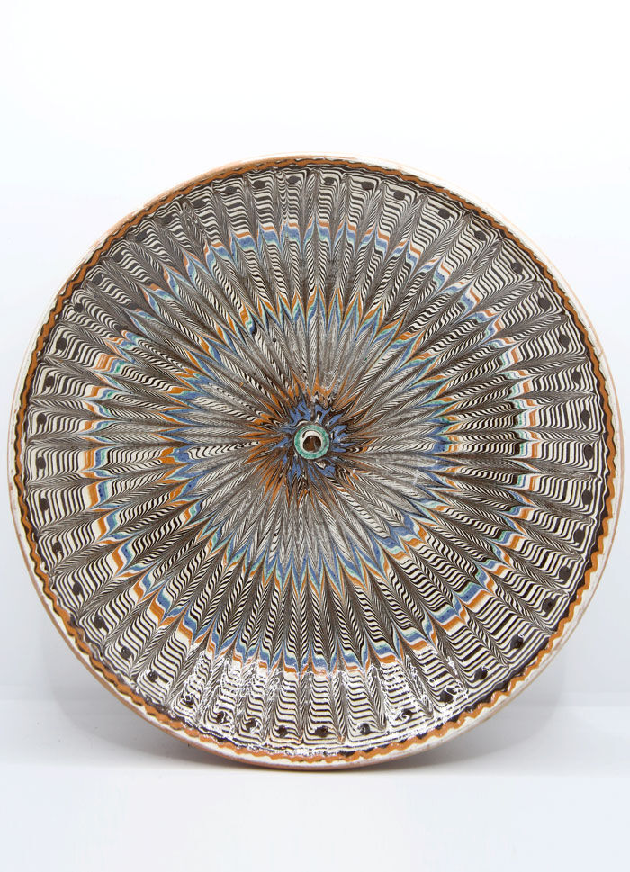 Traditional Romanian plate with psychedelic motifs from Horezu