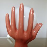 Pair of salmon-colored ceramic "hand" lamps with opaline globe, 80