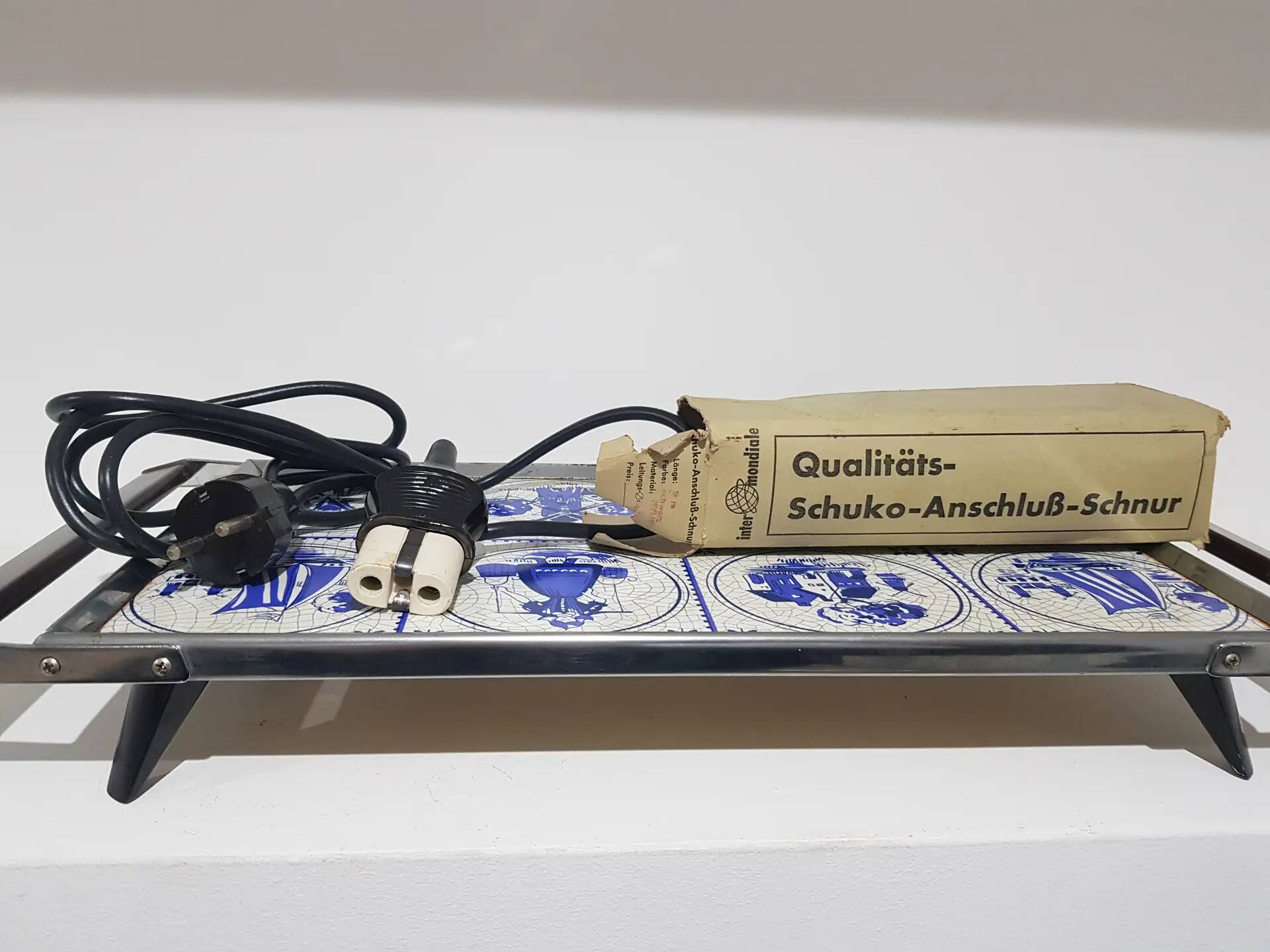 Heating plate, blue and white ceramic, brown rosewood, black metal, Germany, 1970s.
