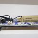 Heating plate, blue and white ceramic, brown rosewood, black metal, Germany, 1970s.