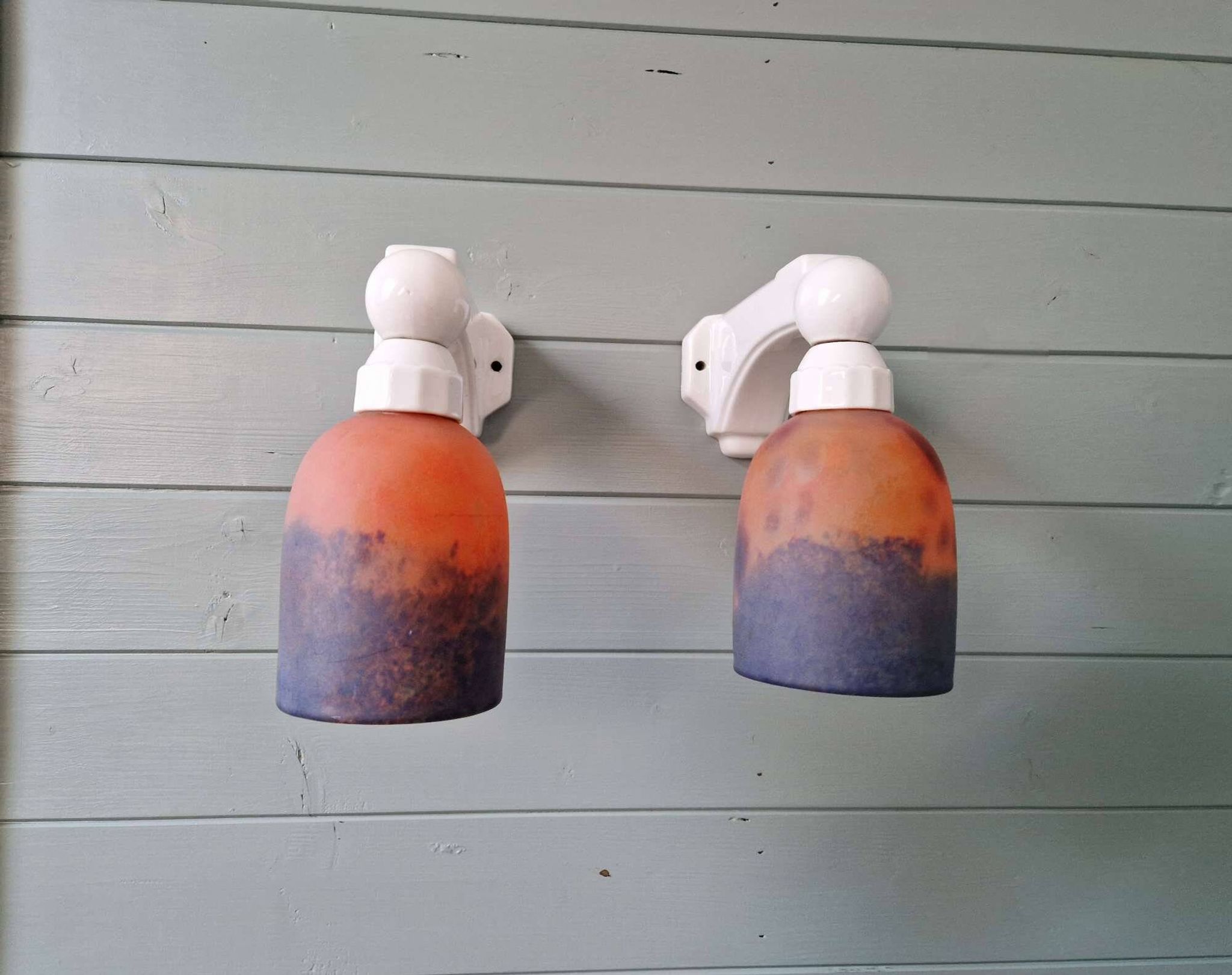 Pair of Art Deco wall sconces in multicoloured porcelain and frosted glass.