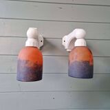 Pair of Art Deco wall sconces in multicoloured porcelain and frosted glass.