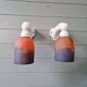 Pair of Art Deco wall sconces in multicoloured porcelain and frosted glass.