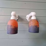 Pair of Art Deco wall sconces in multicoloured porcelain and frosted glass.