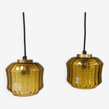 Hanging lamps with an outer shade of an amber coloured/olive green glass shade