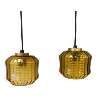 Hanging lamps with an outer shade of an amber coloured/olive green glass shade