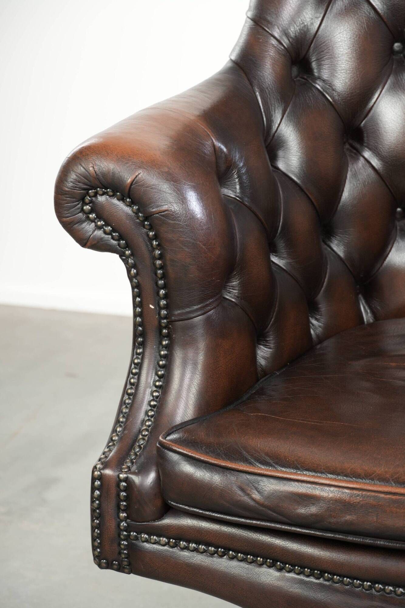 Brown cow leather Chesterfield office chair on wheels in English style