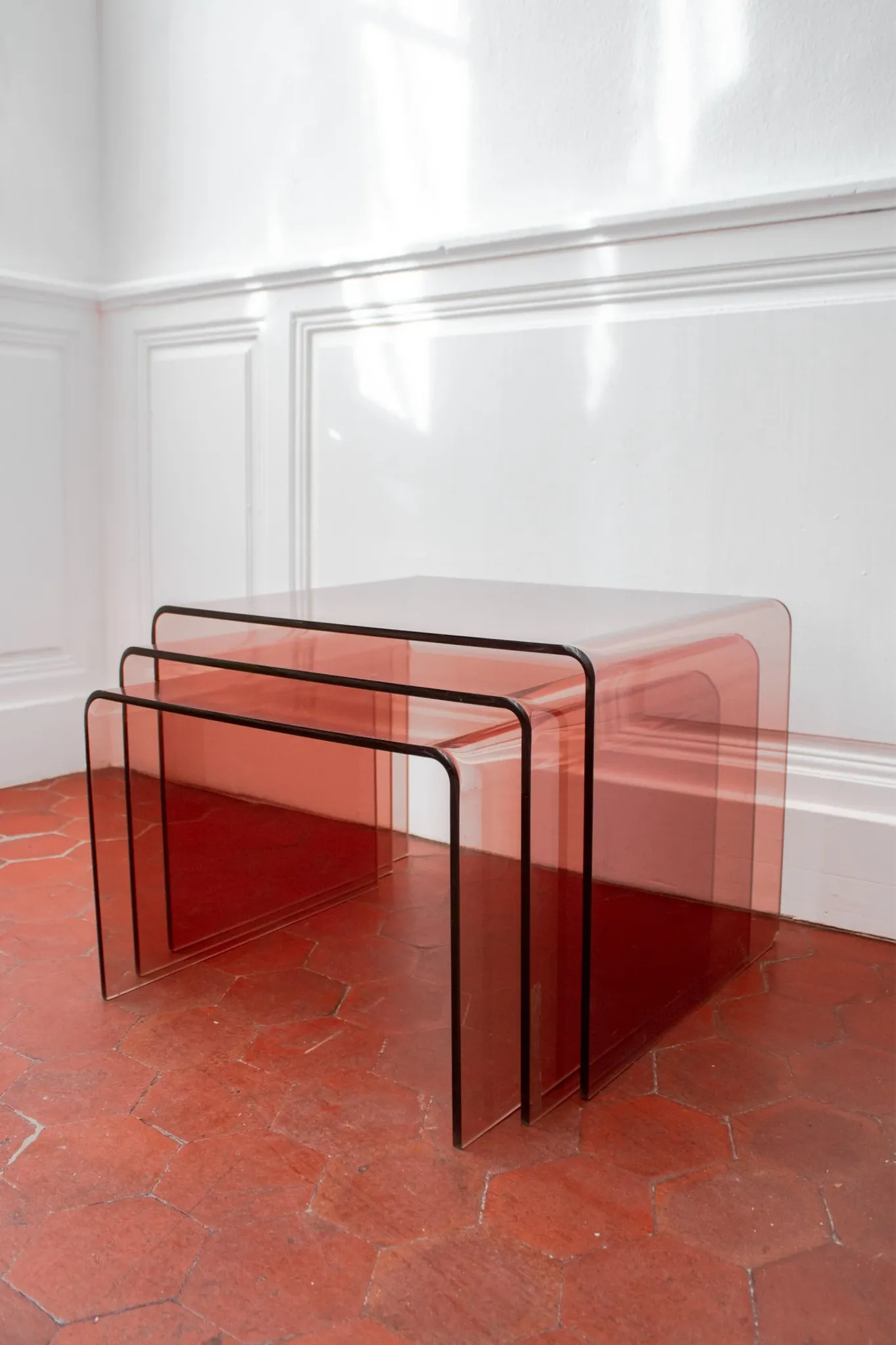 Vintage trio of nesting tables in smoked plexiglass by Michel Dumas, year