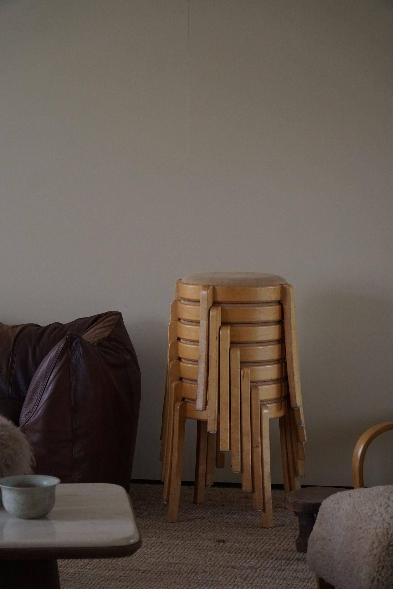 Modern Swedish, set of 14 stackable stools in birch and hessian fabric, 1980s.