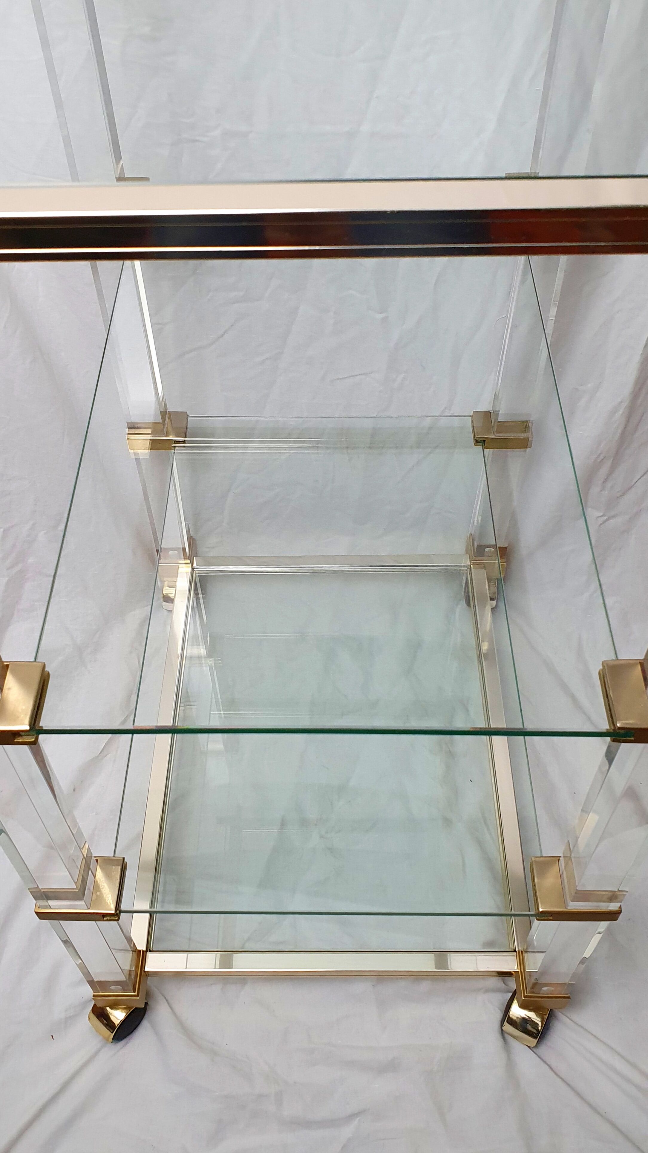 Rolling glass and plexiglass shelf by Pierre Vandel