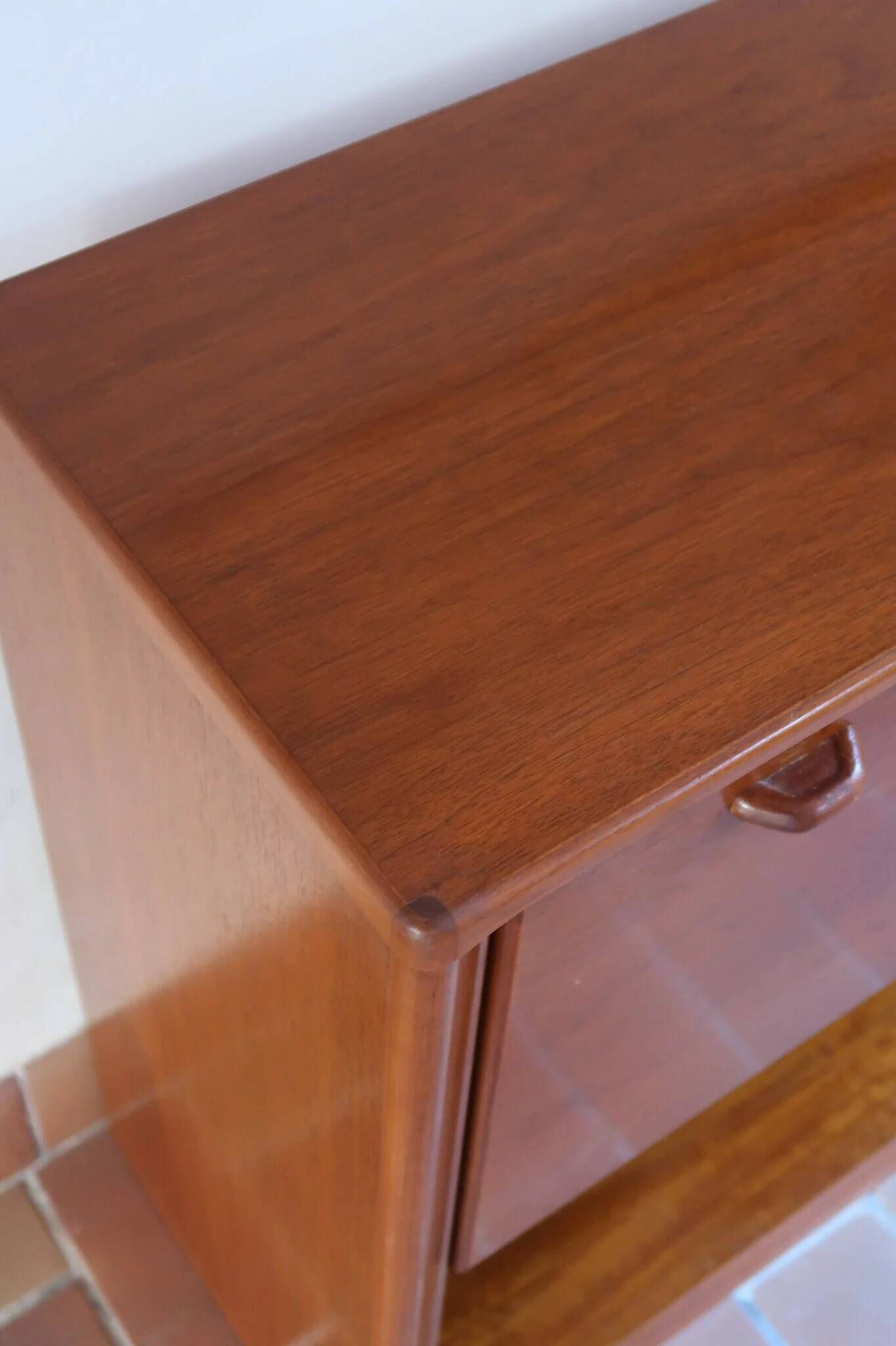 Vintage teak bar cabinet with black glass interior.