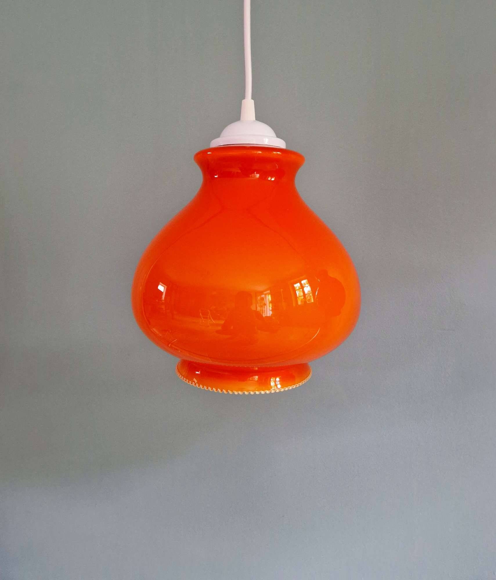 Trio of vintage orange opaline pendant lights, 1960-70