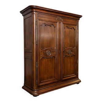 Important Louis XV period wardrobe, richly moulded in solid walnut.