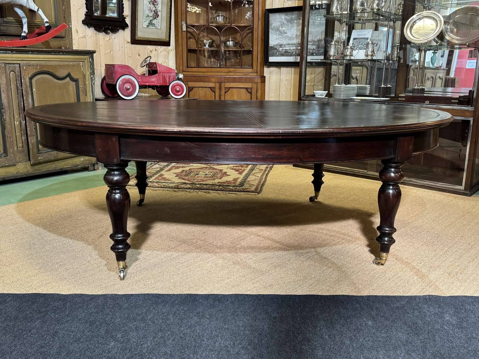Large English library table in dark walnut with a leather top.