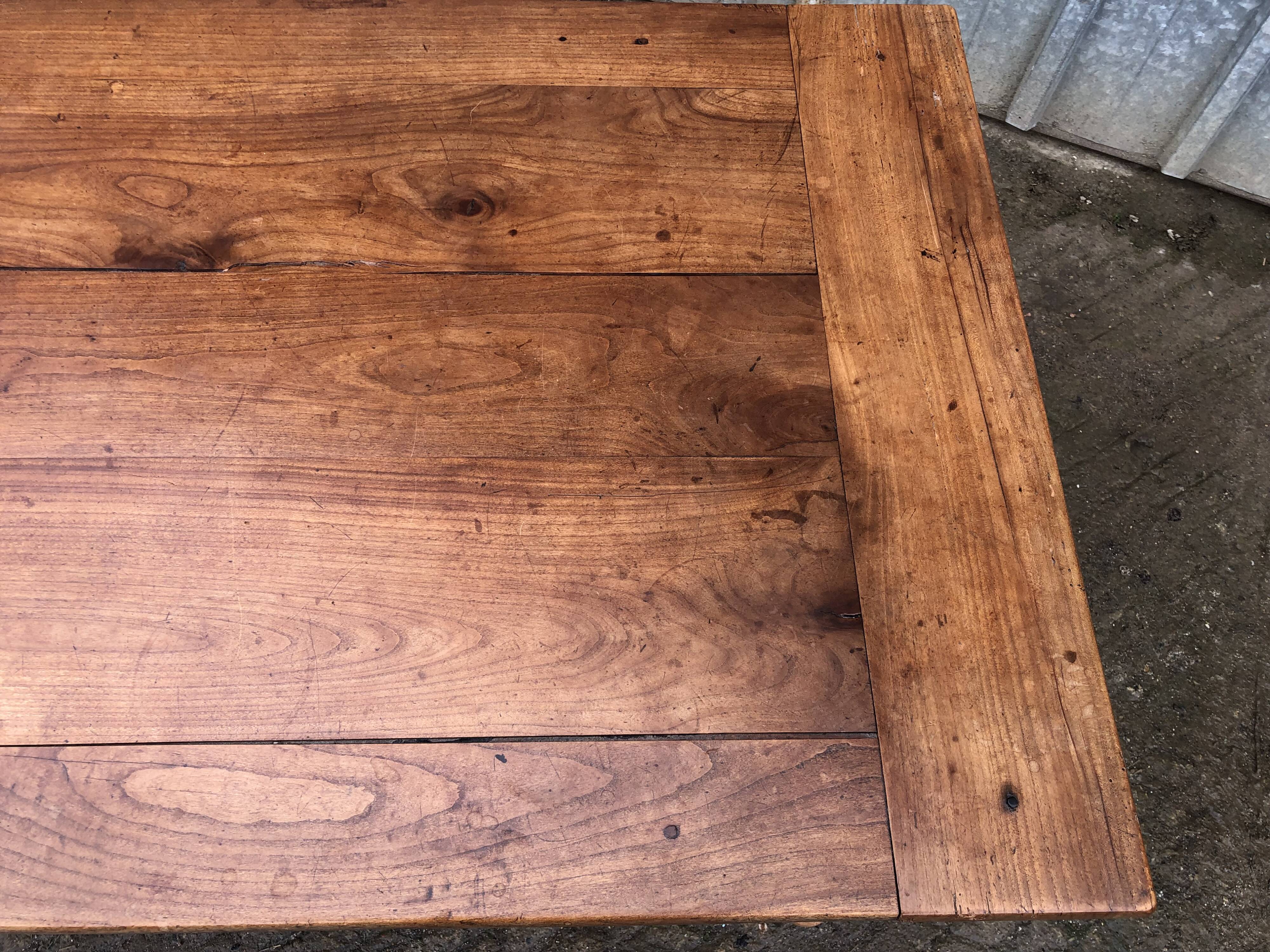 Antique solid cherry farmhouse table with 2 end drawers and 1 pull-out.