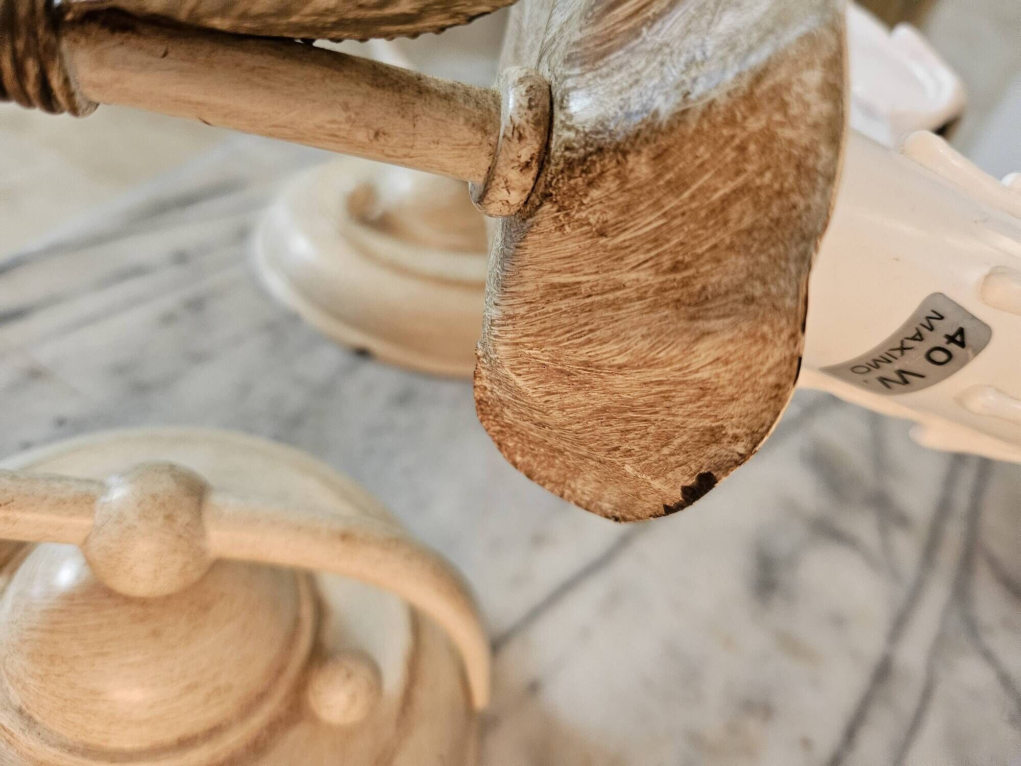 Pair of cream patinated metal wall sconces with floral decoration.