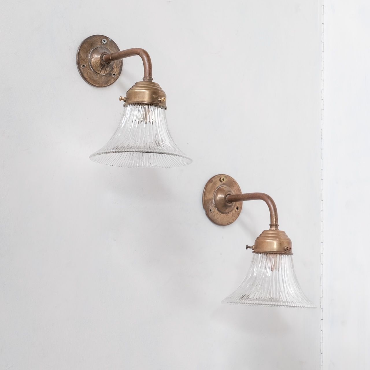 Pair of brass and holophane glass french mid-century wall lights