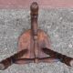 Low wooden tripod stool.