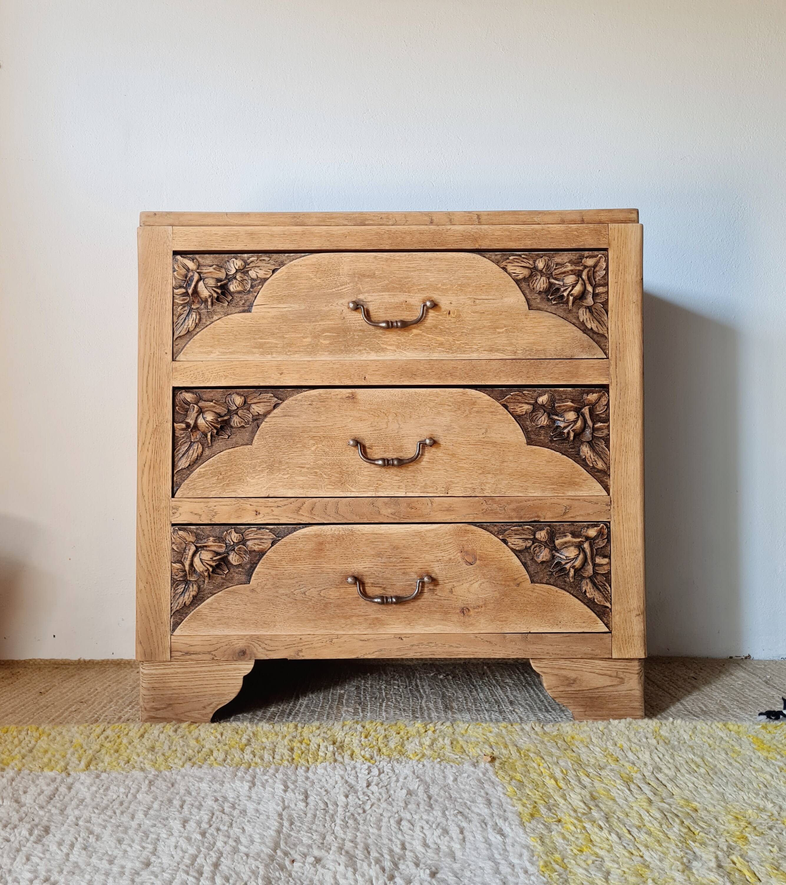 Art Deco chest of drawers in raw oak with carved drawers.