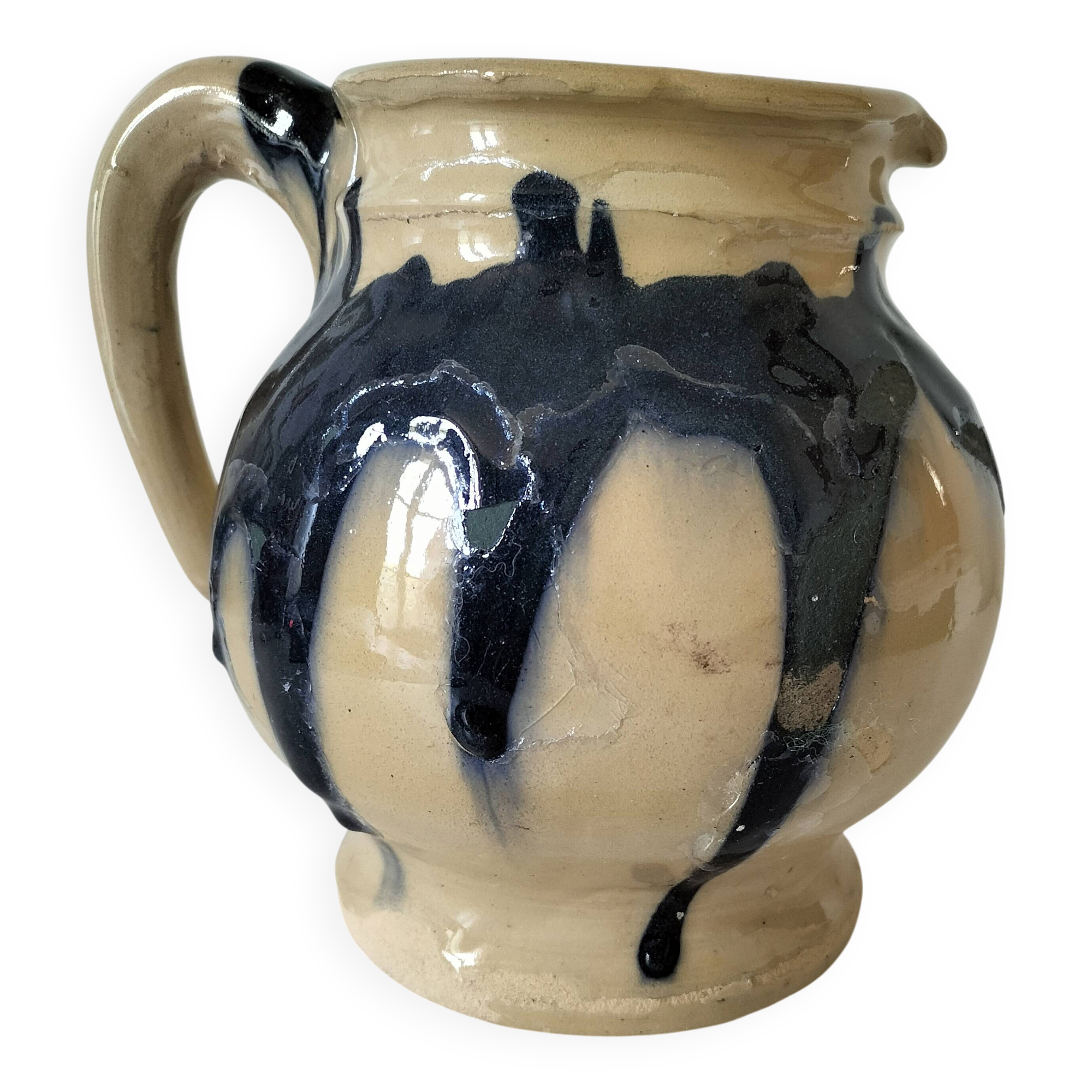 handcrafted ceramic jug with navy blue drip glaze.
