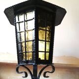 Large hanging lantern in wrought iron and opaque yellow-orange windows