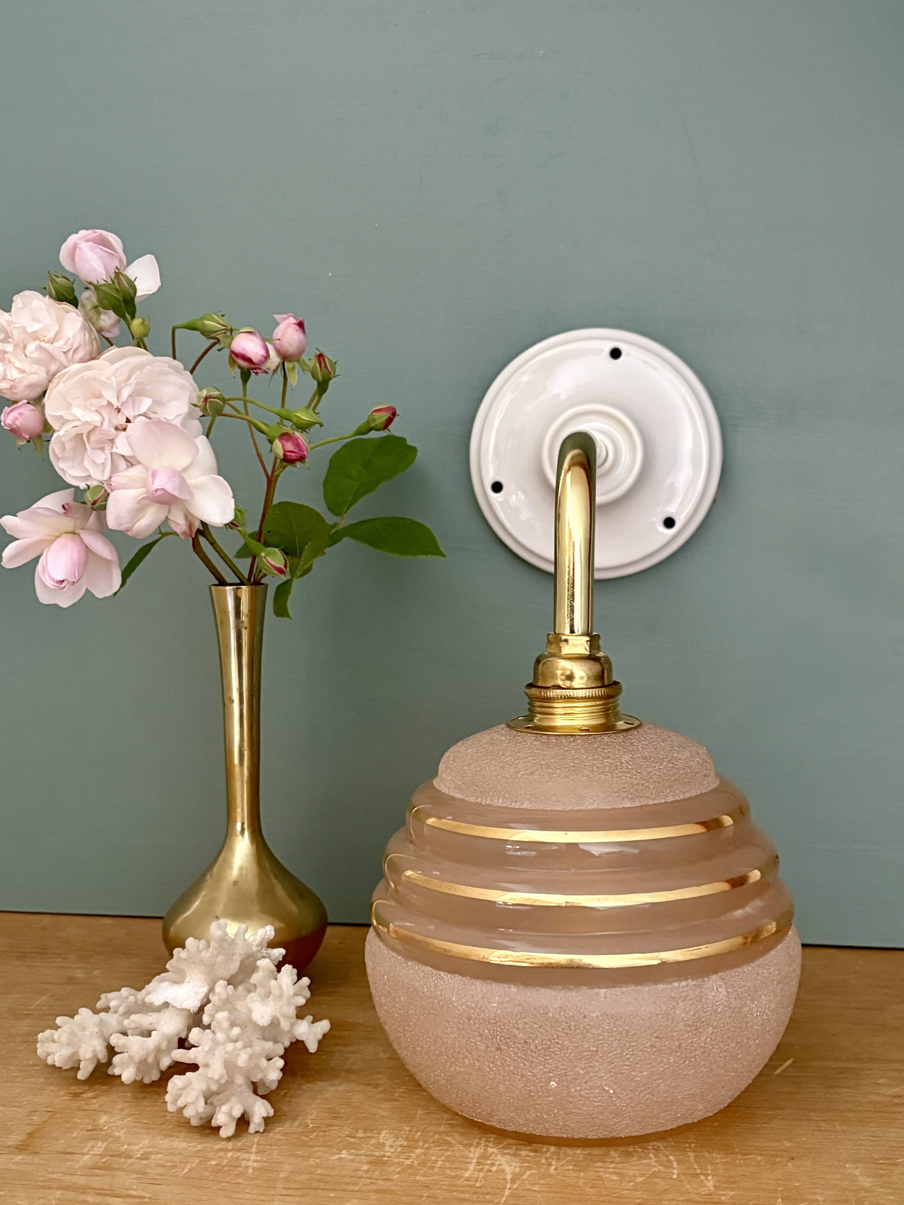 Vintage pink and gold frosted glass globe wall light.
