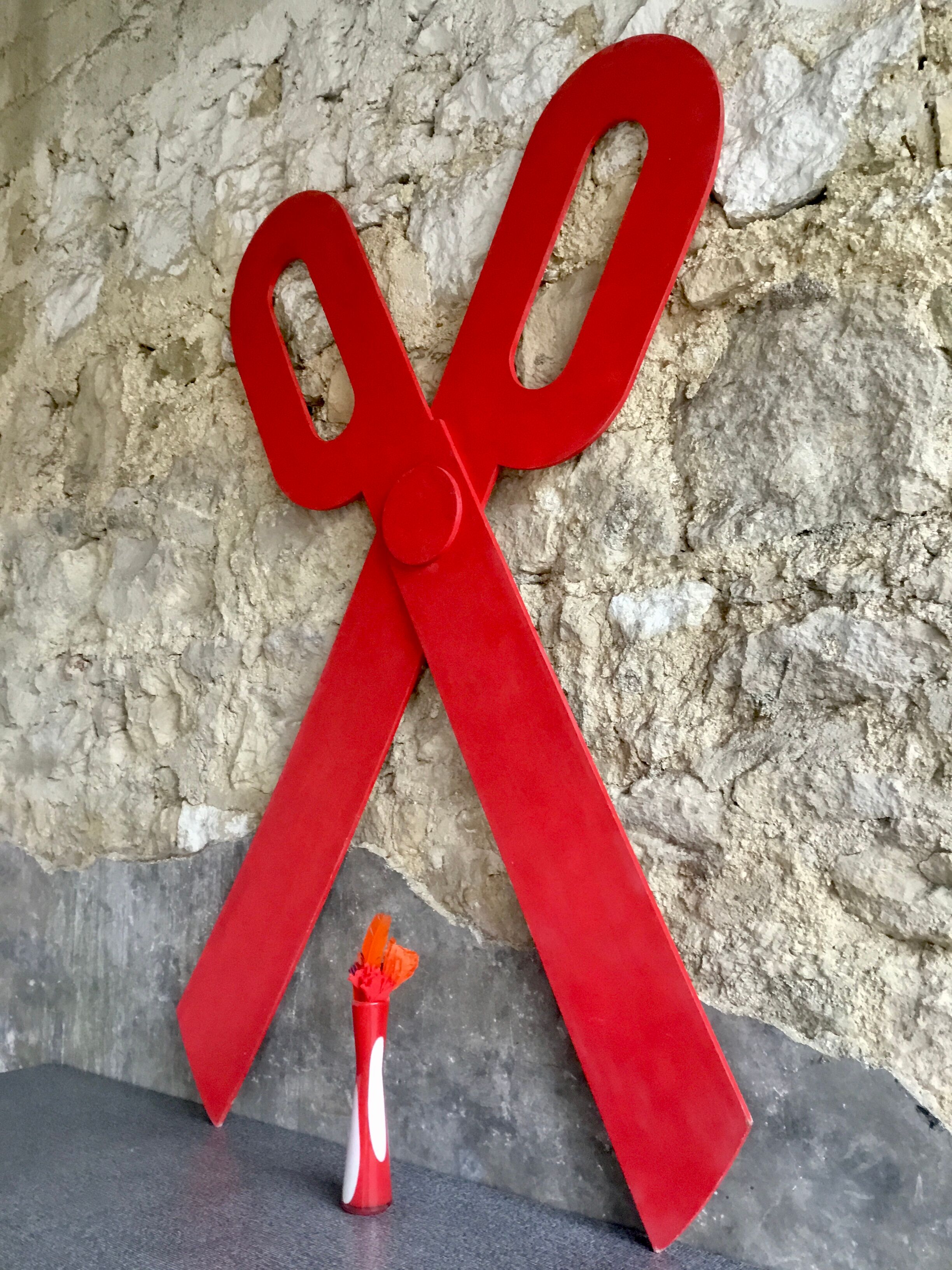 Wooden sign in the shape of scissors