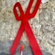 Wooden sign in the shape of scissors