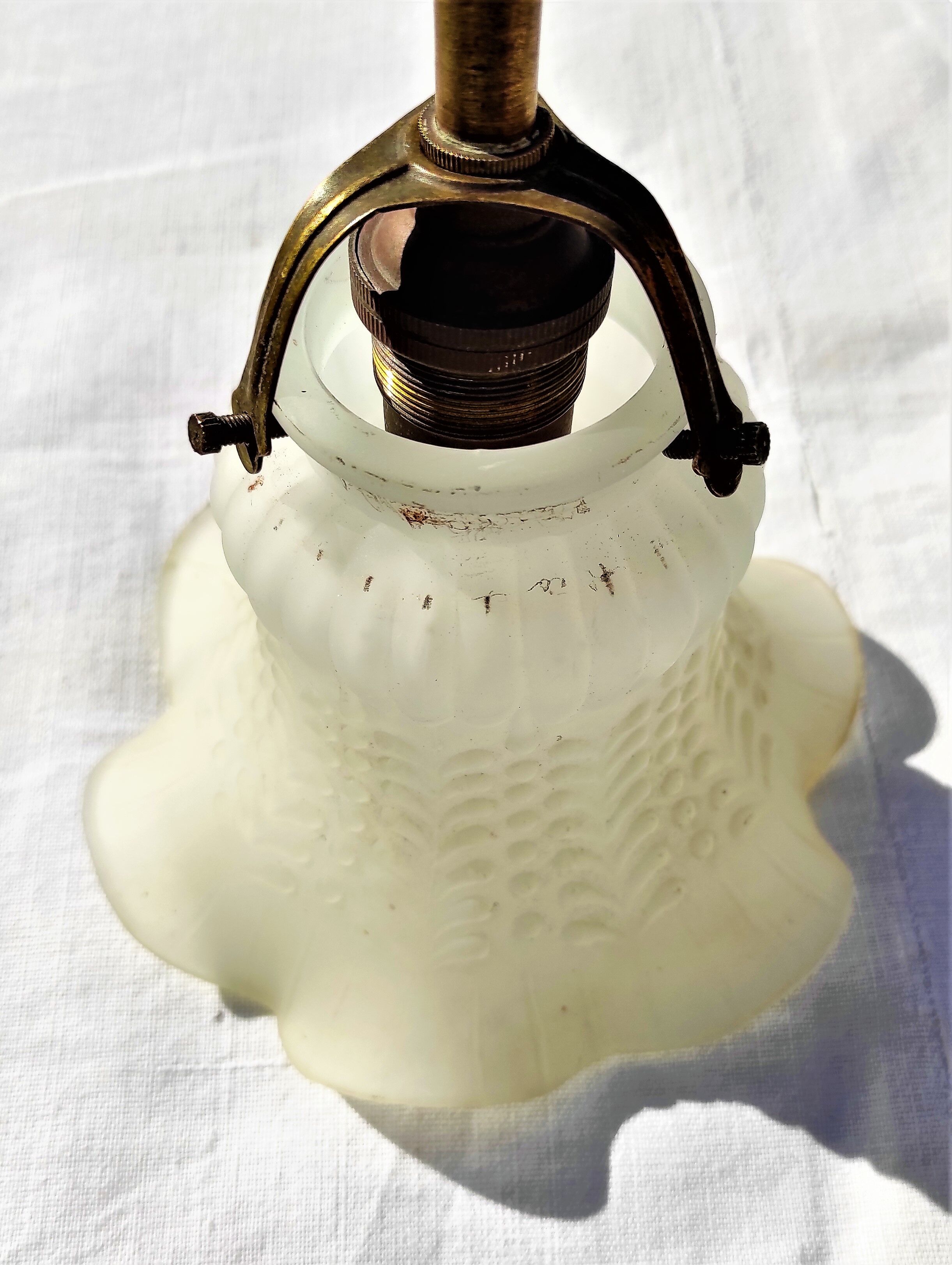 Brass gooseneck wall lamp, with brass socket and porcelain base.