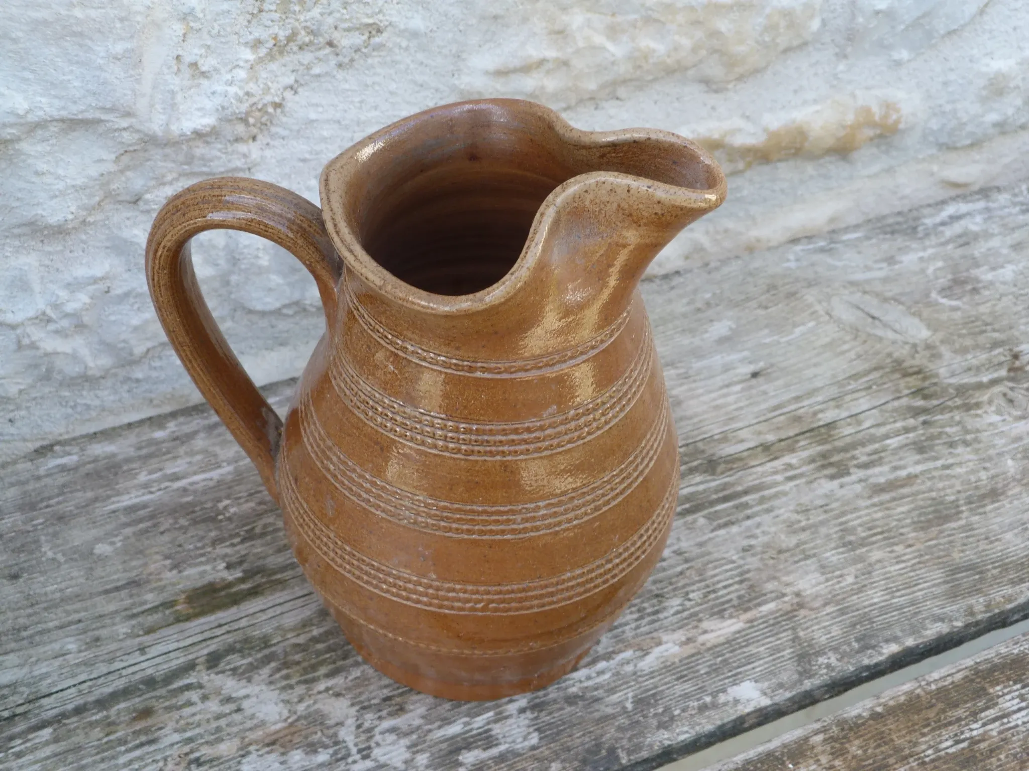 Old stoneware wine jug with patterns
