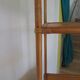 Storage column, wooden bookshelf and woven rattan.