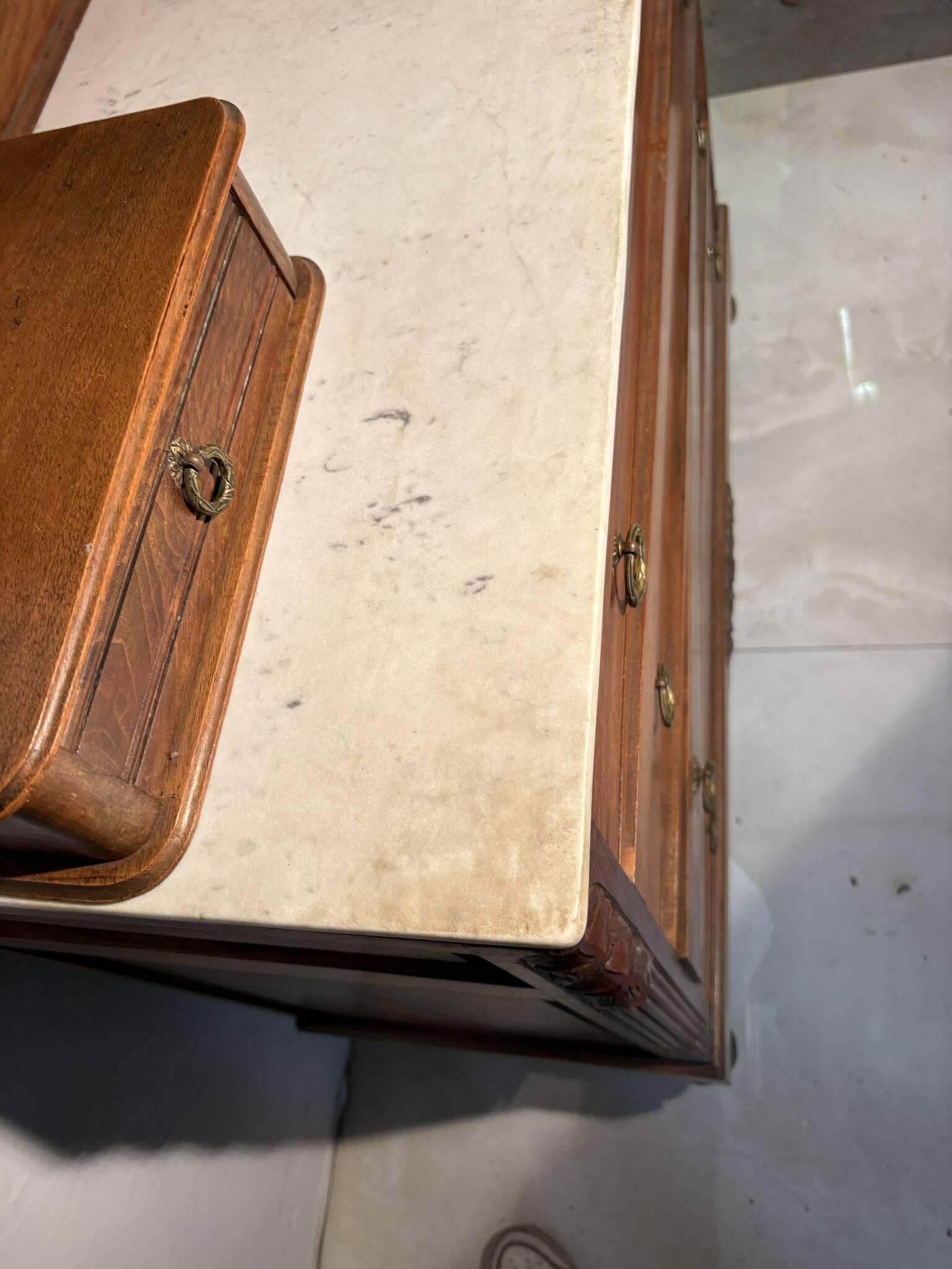 Antique carved wooden dressing table with marble and tilting oval mirror.