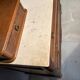 Antique carved wooden dressing table with marble and tilting oval mirror.