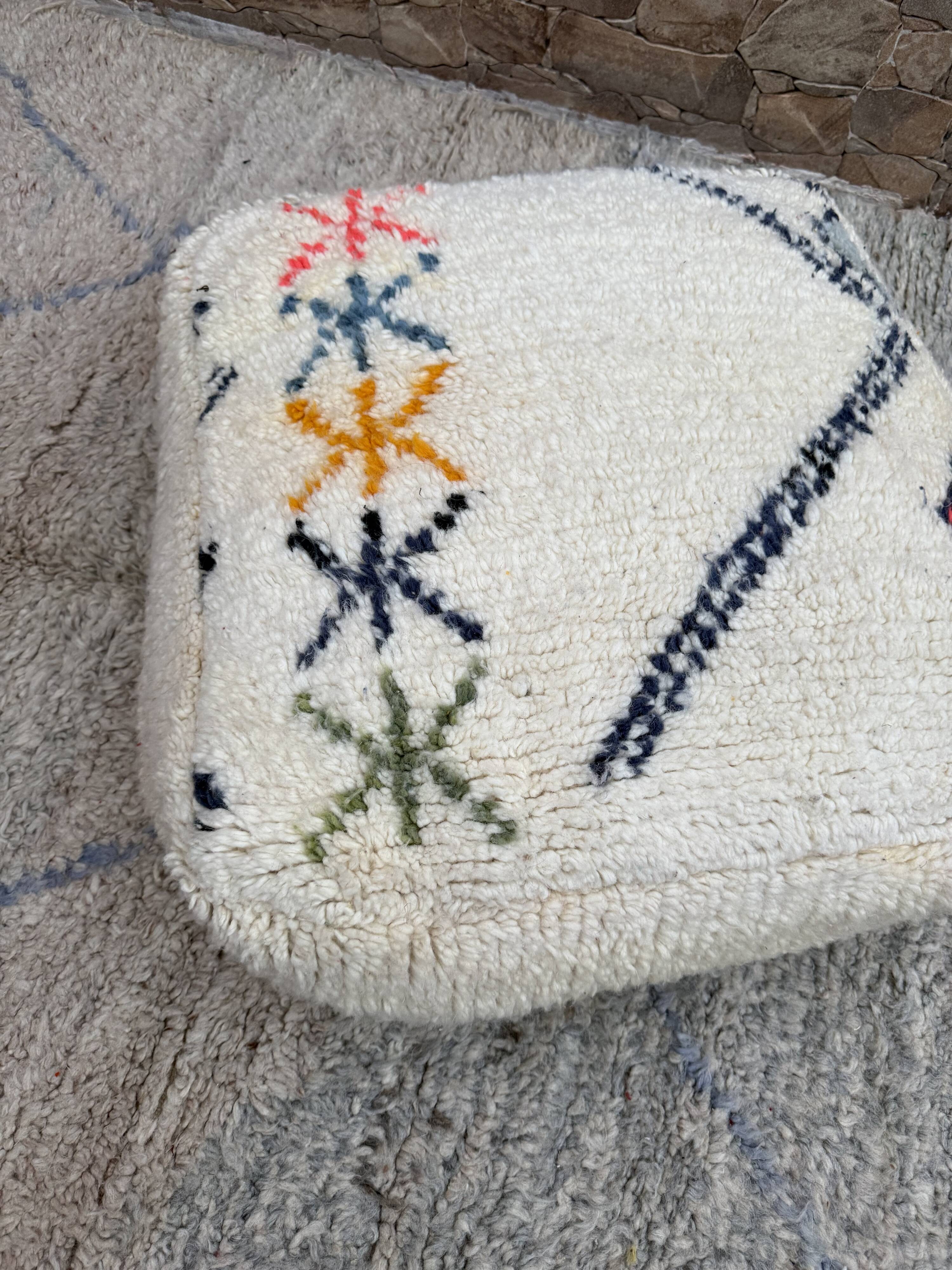 Berber floor pouf: Handwoven Moroccan wool cushion.