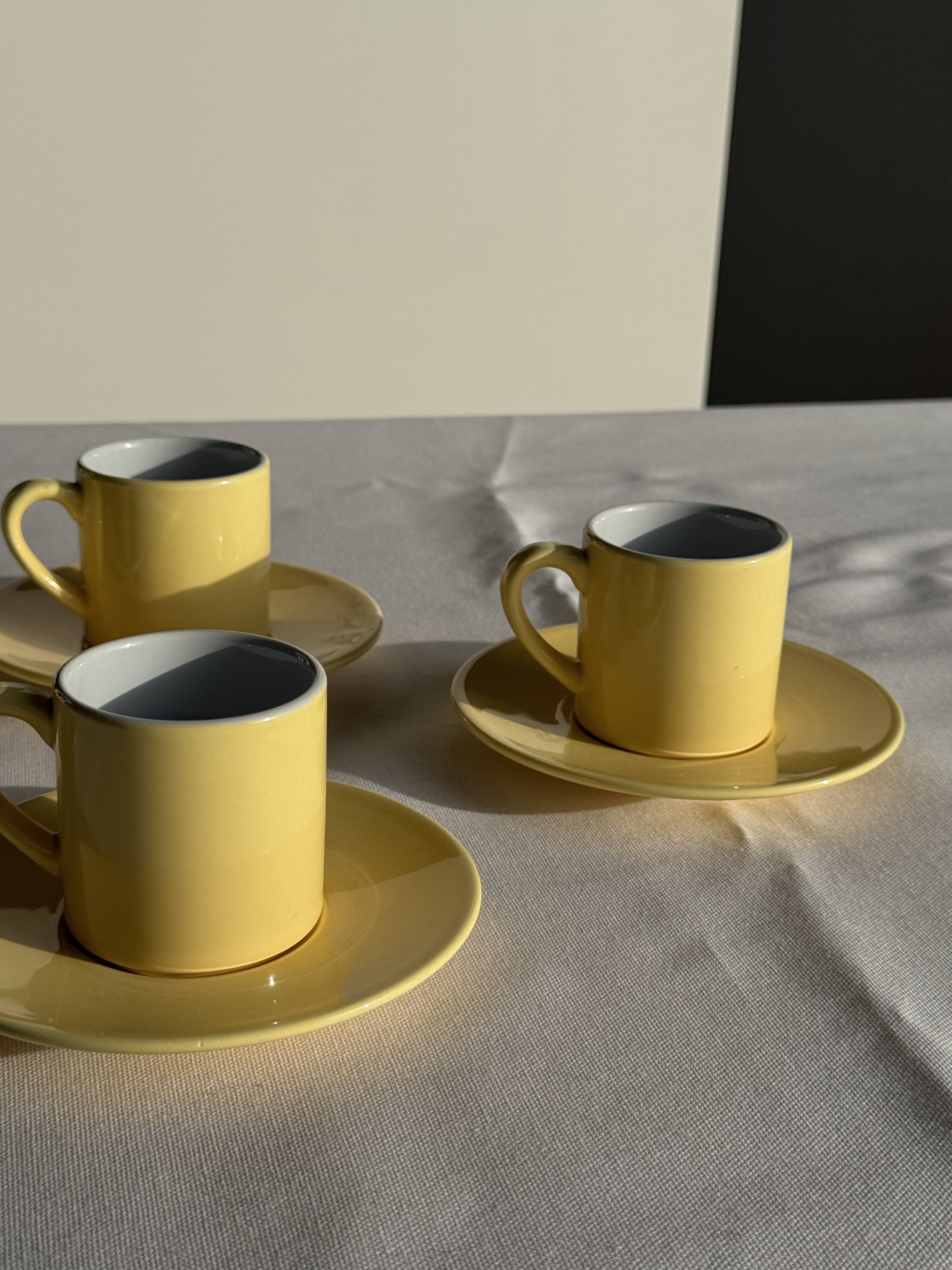 Set of 4 vintage yellow Italian espresso cups and saucers.