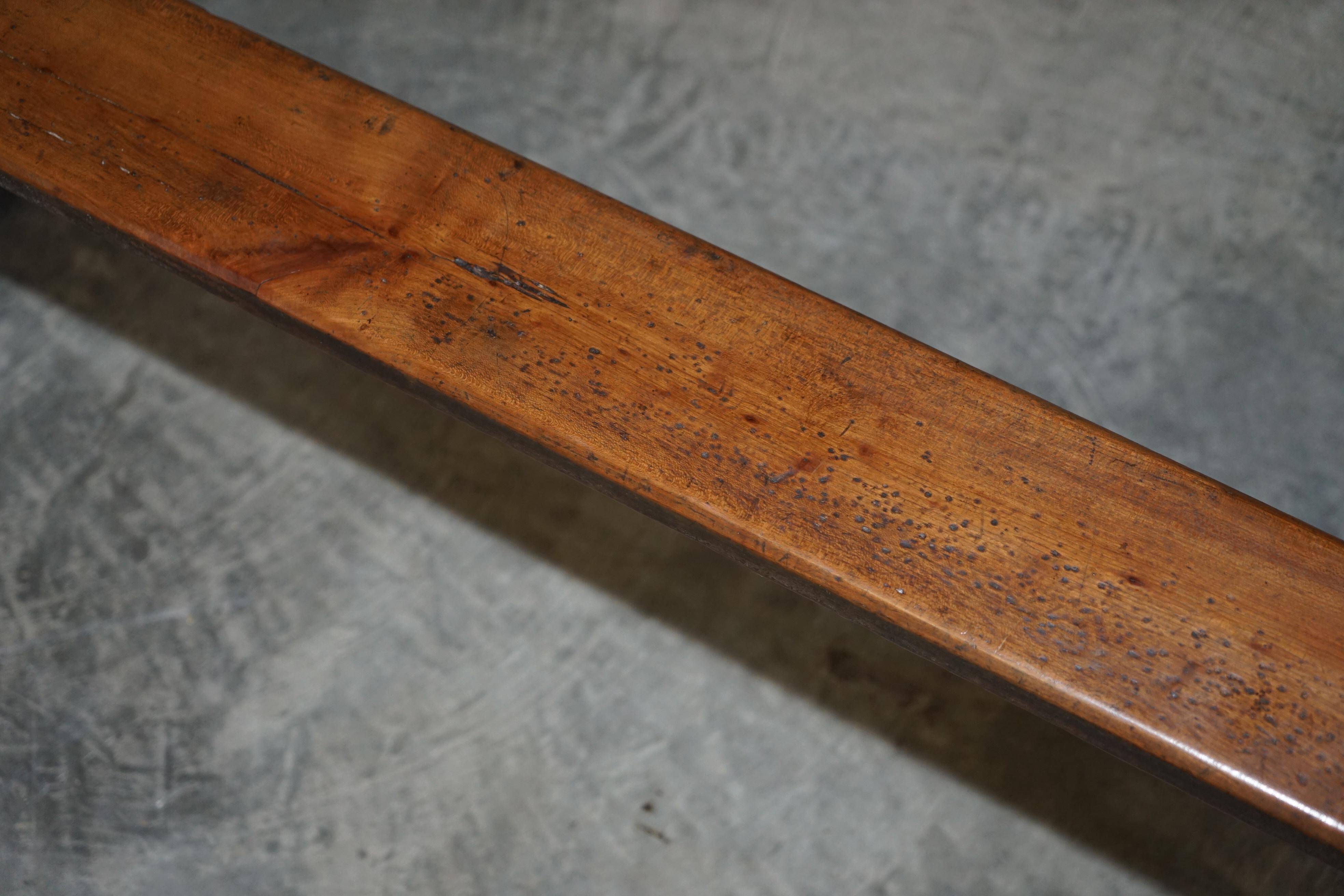Pair of antique Victorian trestle benches in fruitwood.