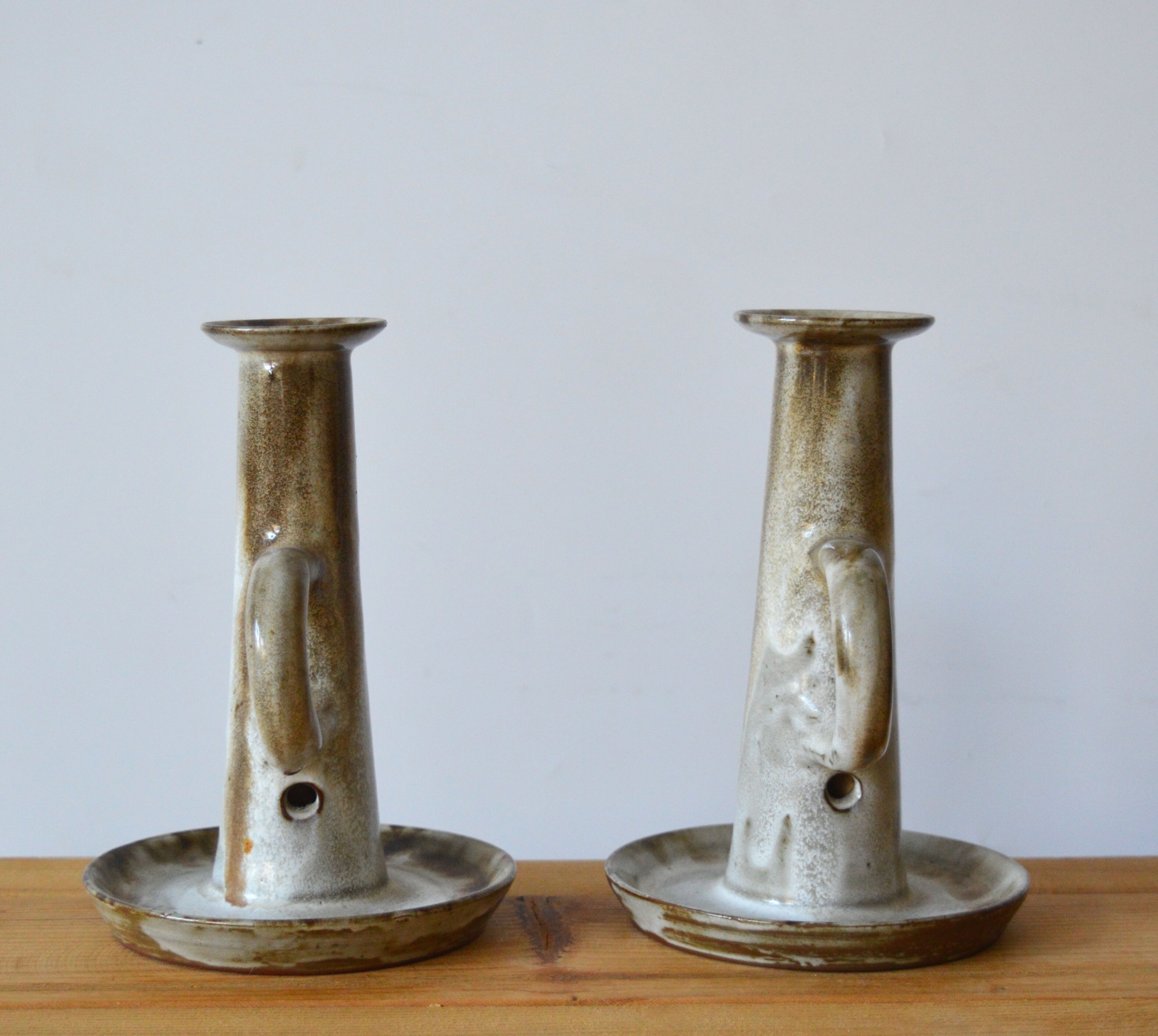 Duo of sandstone candlesticks
