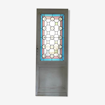 Old Bordeaux wooden door with stained glass window