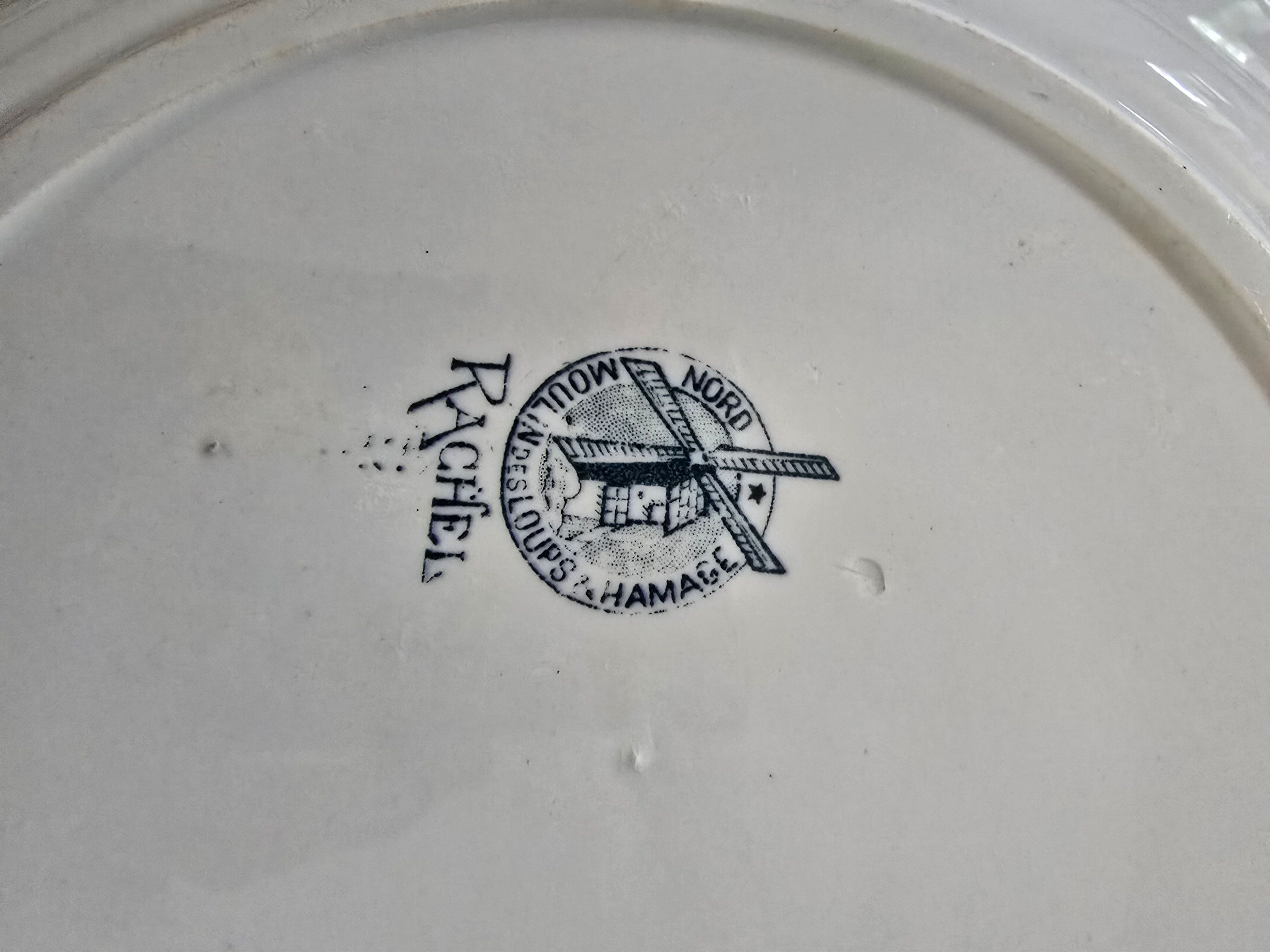 Old green-blue faience plates and dishes with geometric patterns.