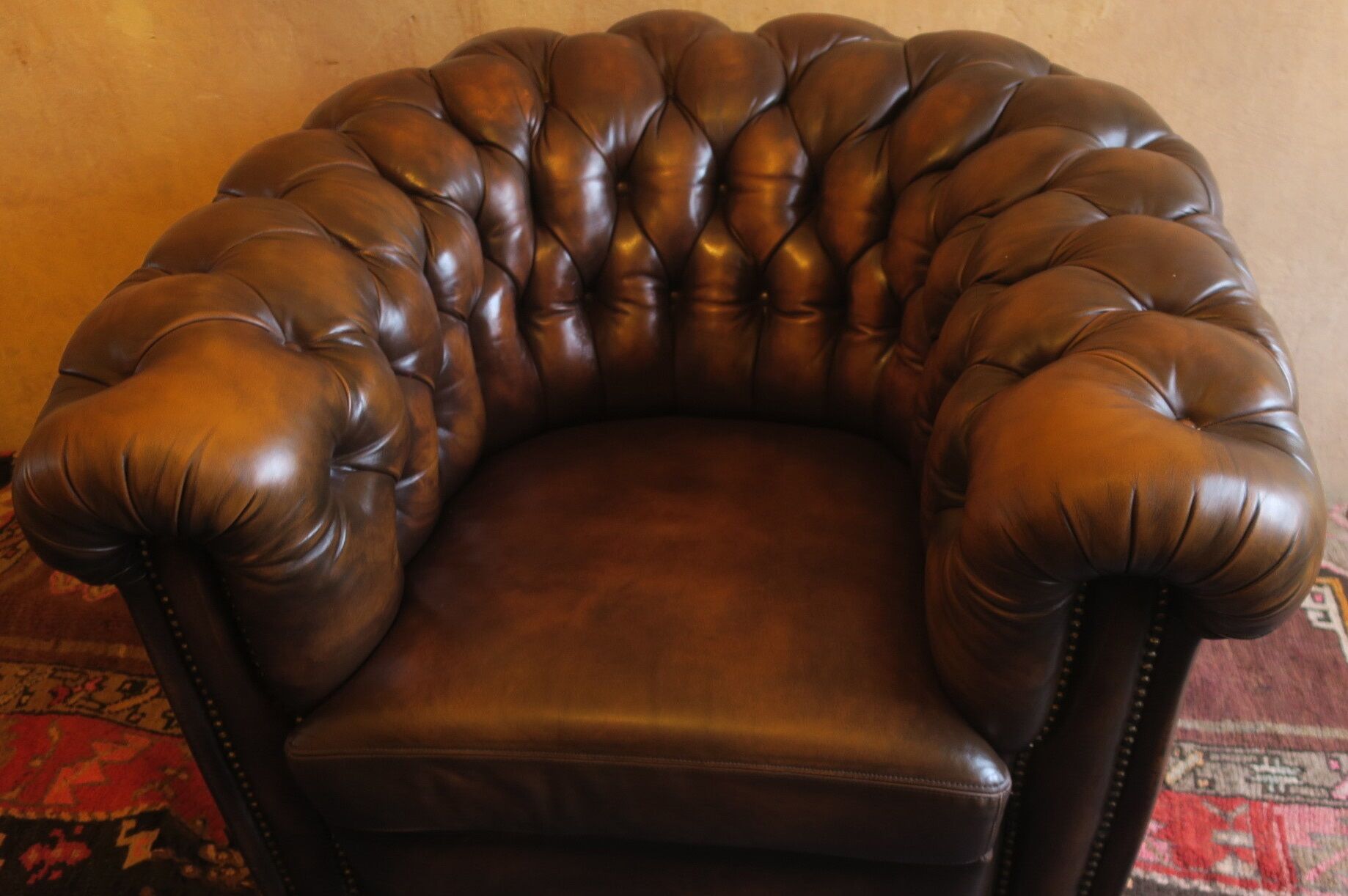 Chesterfield club armchair in patinated chestnut coloured leather
