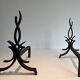 Pair of Wrought Iron Andirons with Stylised Flamboyant Uprights and Enrobed Feet